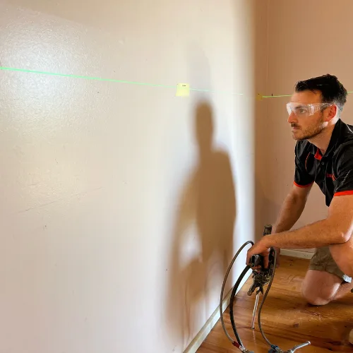 Buildfix technicians injecting GeoPoly™ resin beneath sinking brick piers