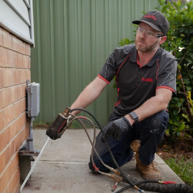 Buildfix technicians injecting GeoPoly™ resin beneath foundations