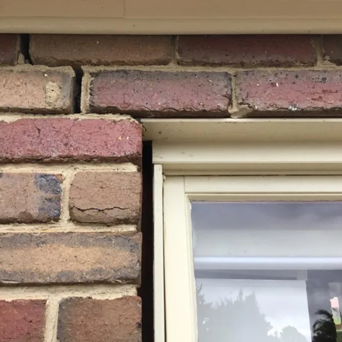 Gap opening between brickwork and window frame caused by foundation subsidence