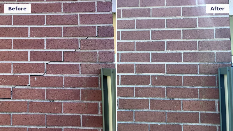 Diagonal stair-step crack in a red brick wall repaired after the foundation was lifted